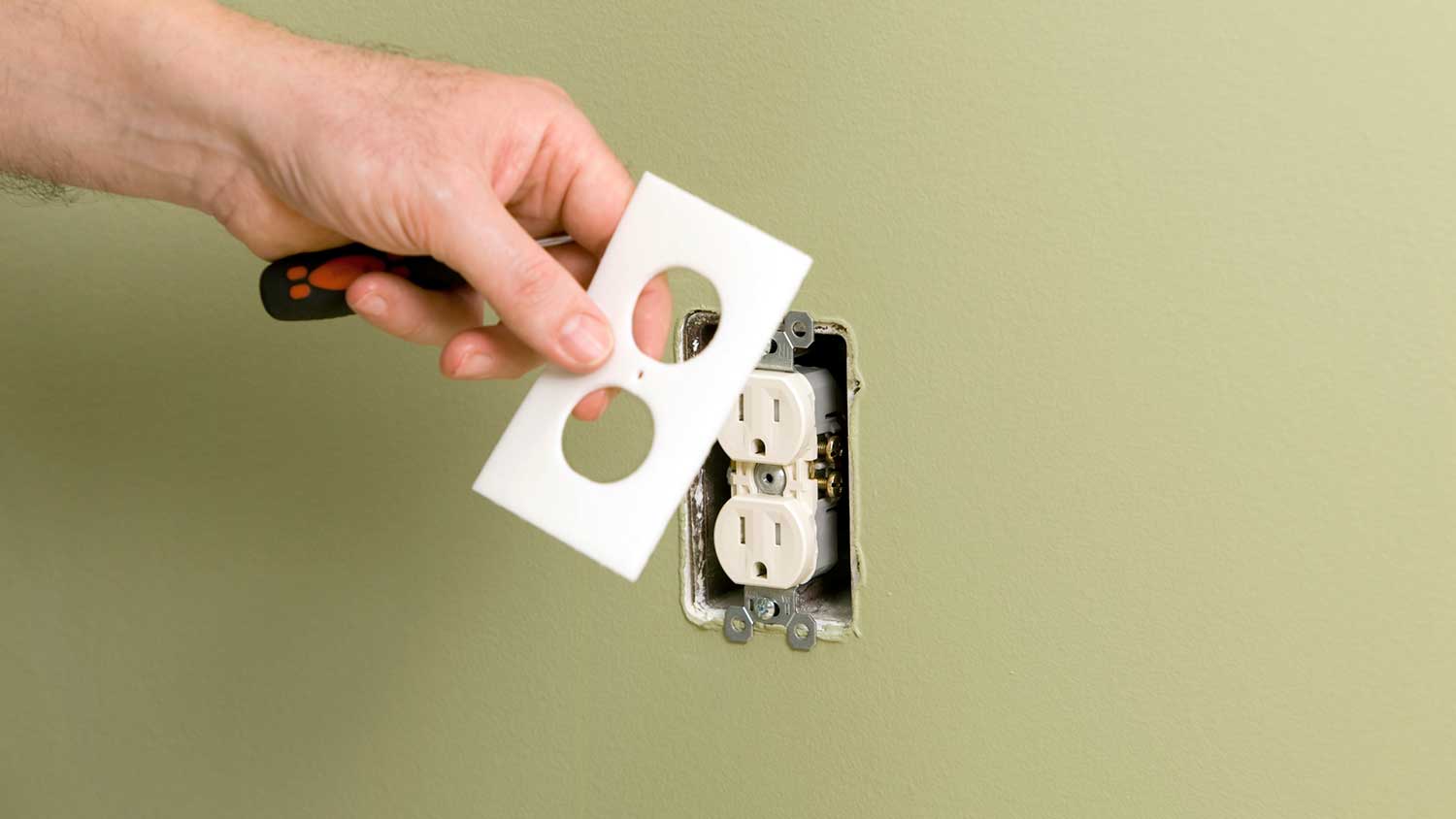 Hand removing outlet cover plate