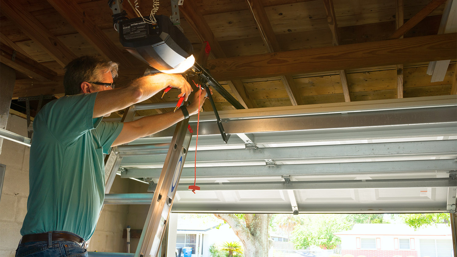 man repairing garage door