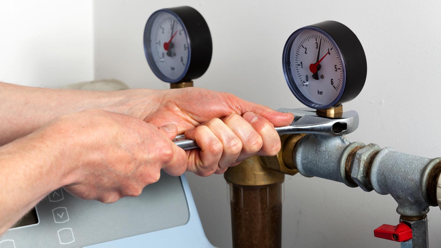 handyman repairing water softener pressure