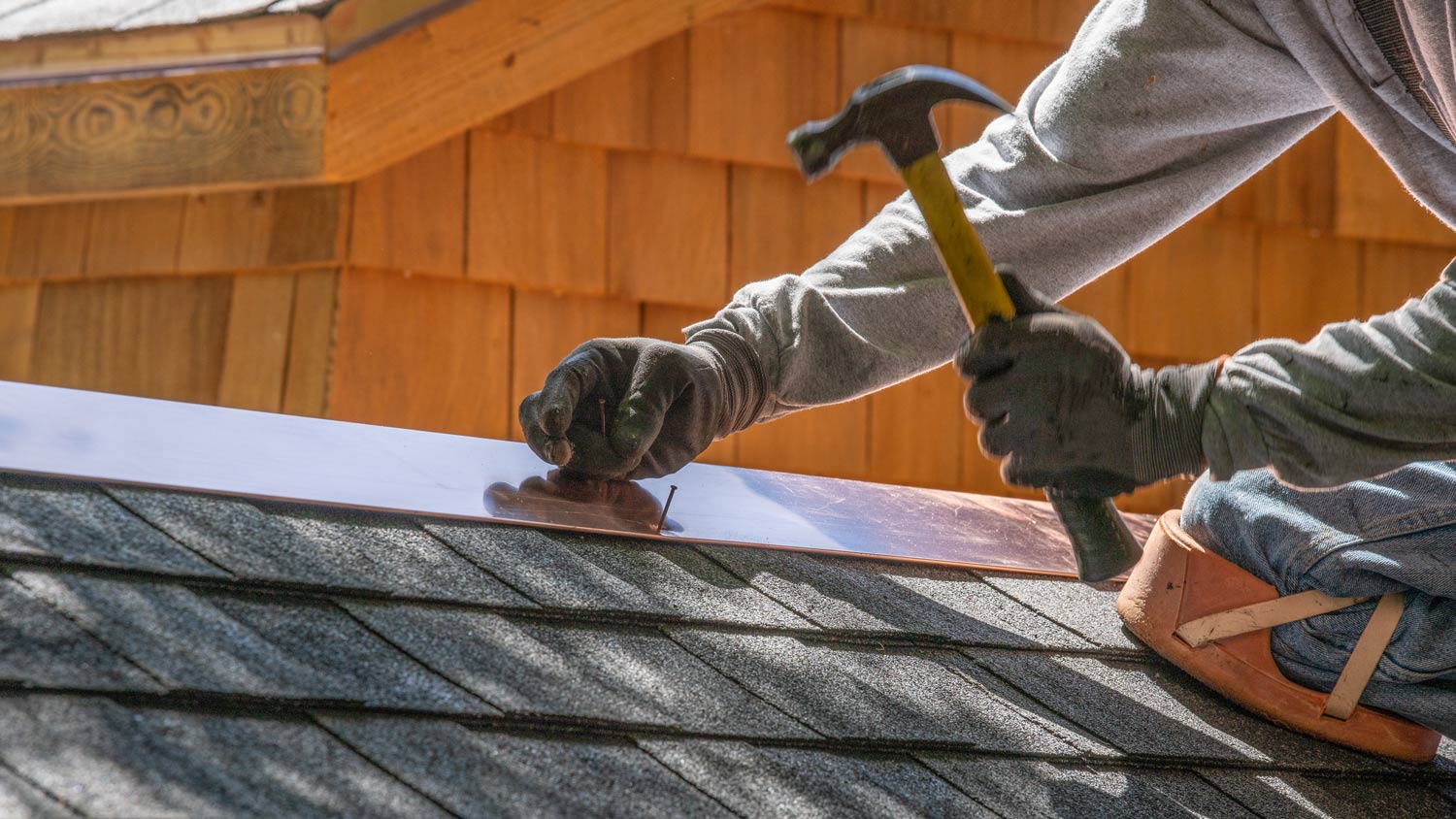 Man installing asphalt roo