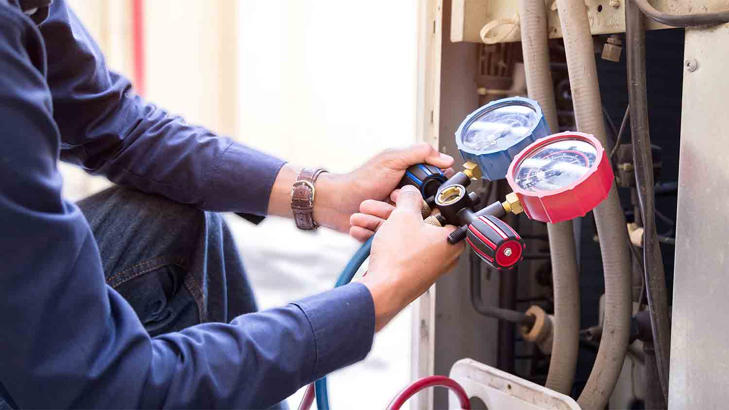 technician outside measuring heat/air pump