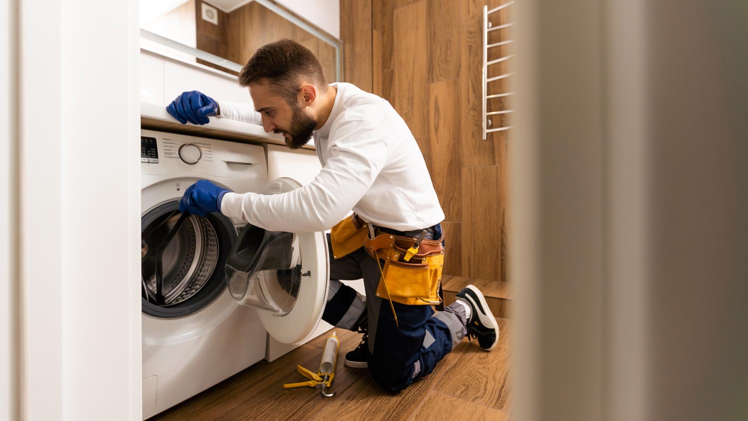 repairman fixing washing machine