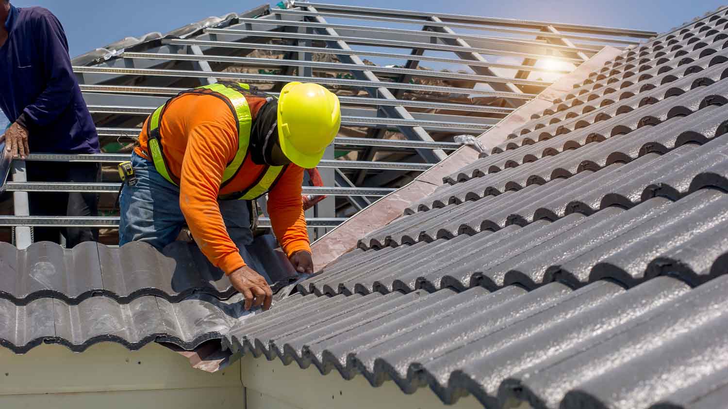 men replacing tiles on roof