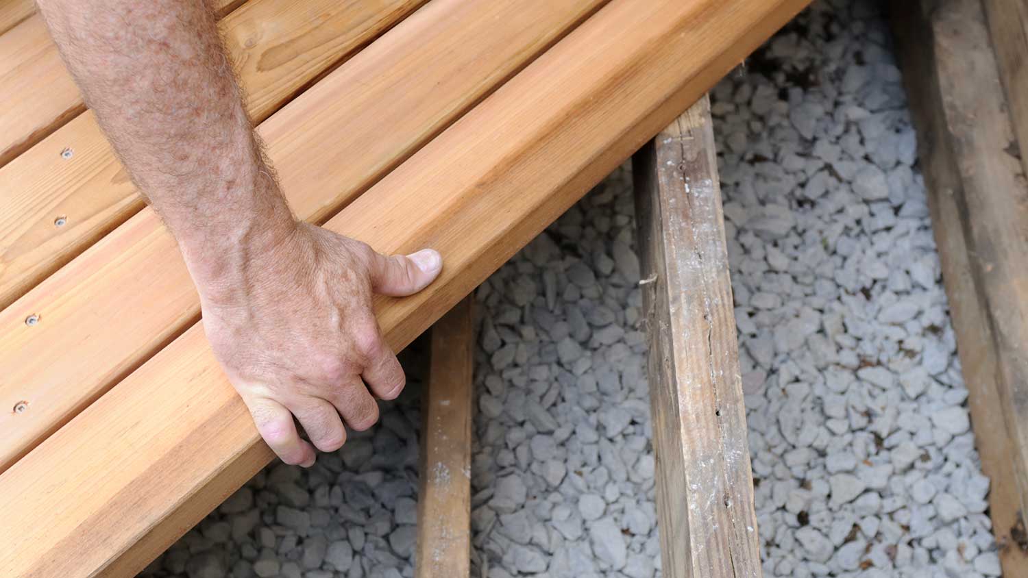 Carpenter installing new deck boards