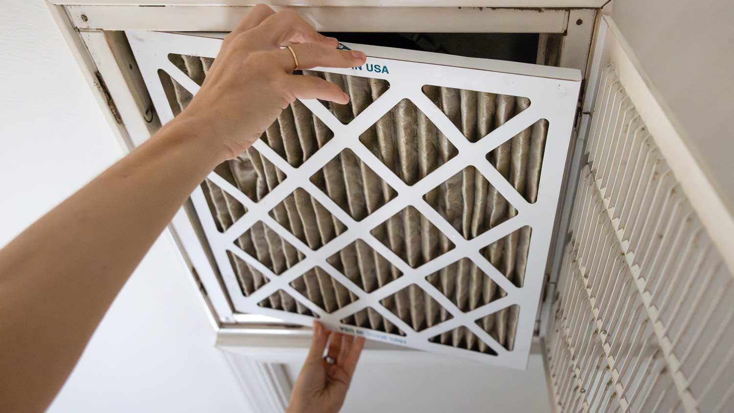 man replacing dirty filter