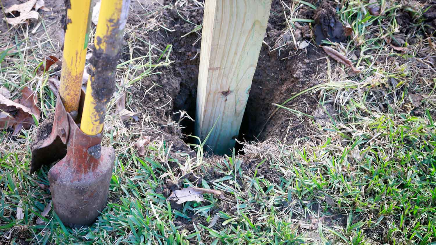 Placing a new post fence in a hole in the ground