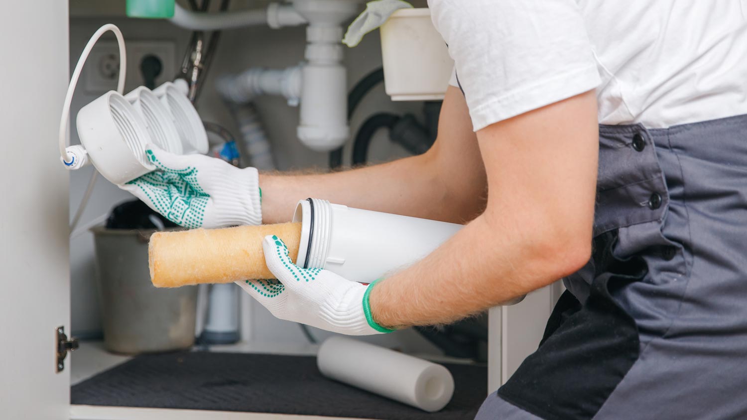 plumber replacing water filter