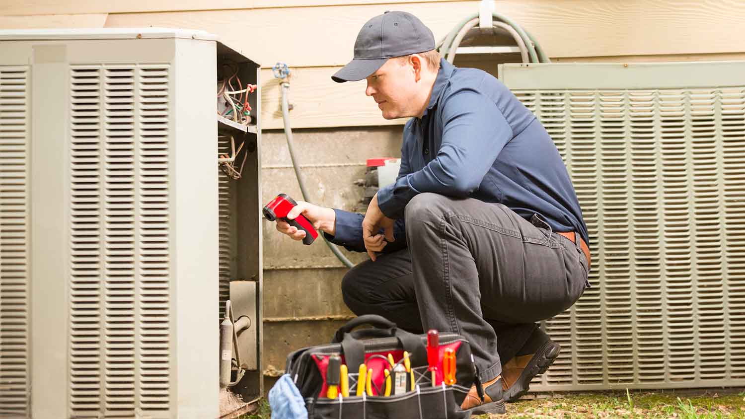 Inspector checking hvac unit outside of the house