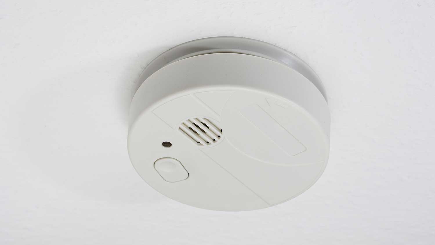 Smoke detector installed on a white ceiling