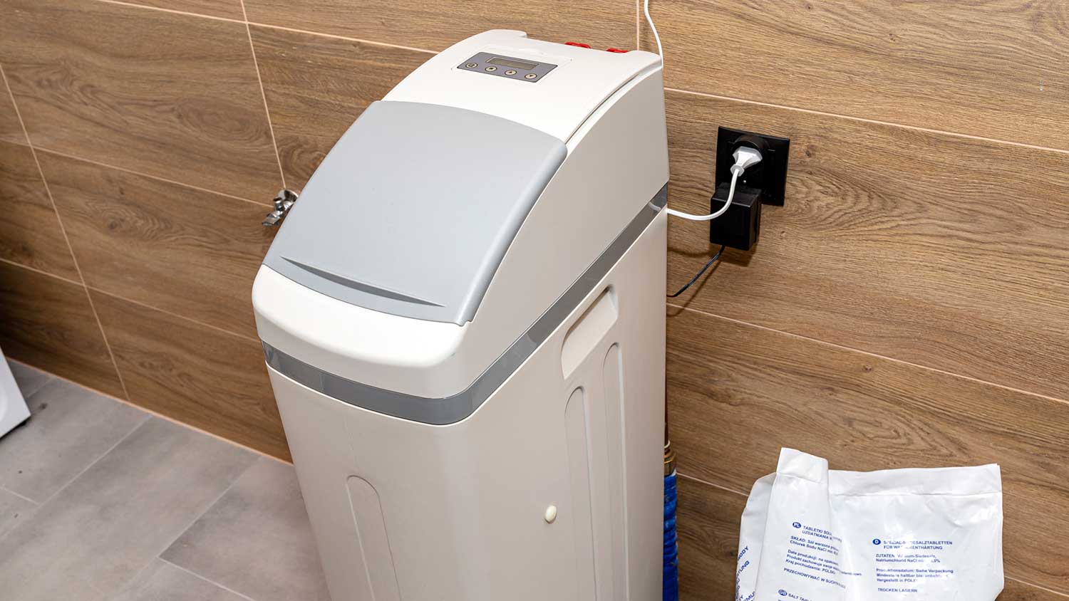 Residential water softener machine in a boiler room