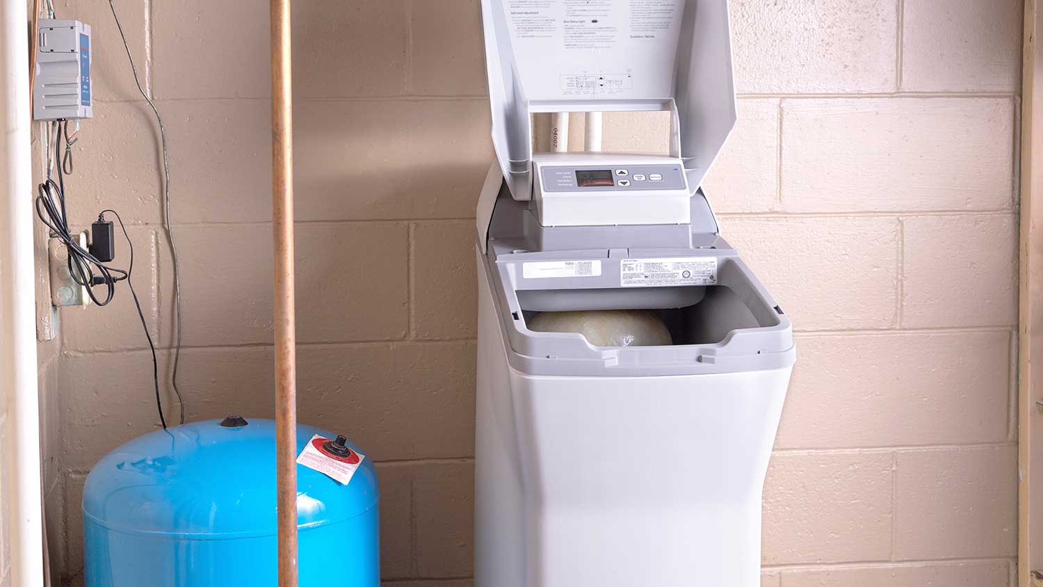 Ion exchange water softener installed in the basement