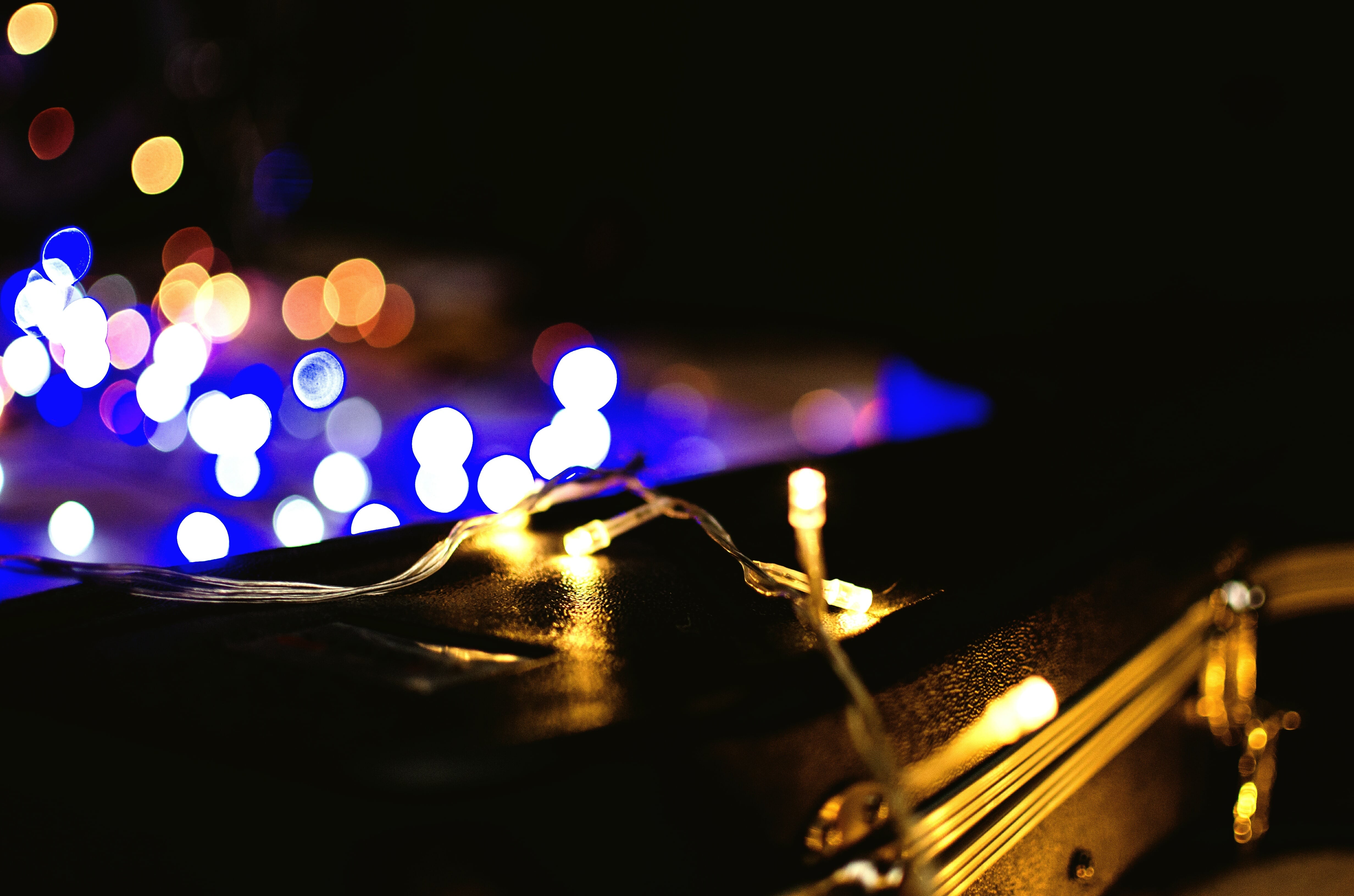 A retaining wall at night with string lights overtop of it