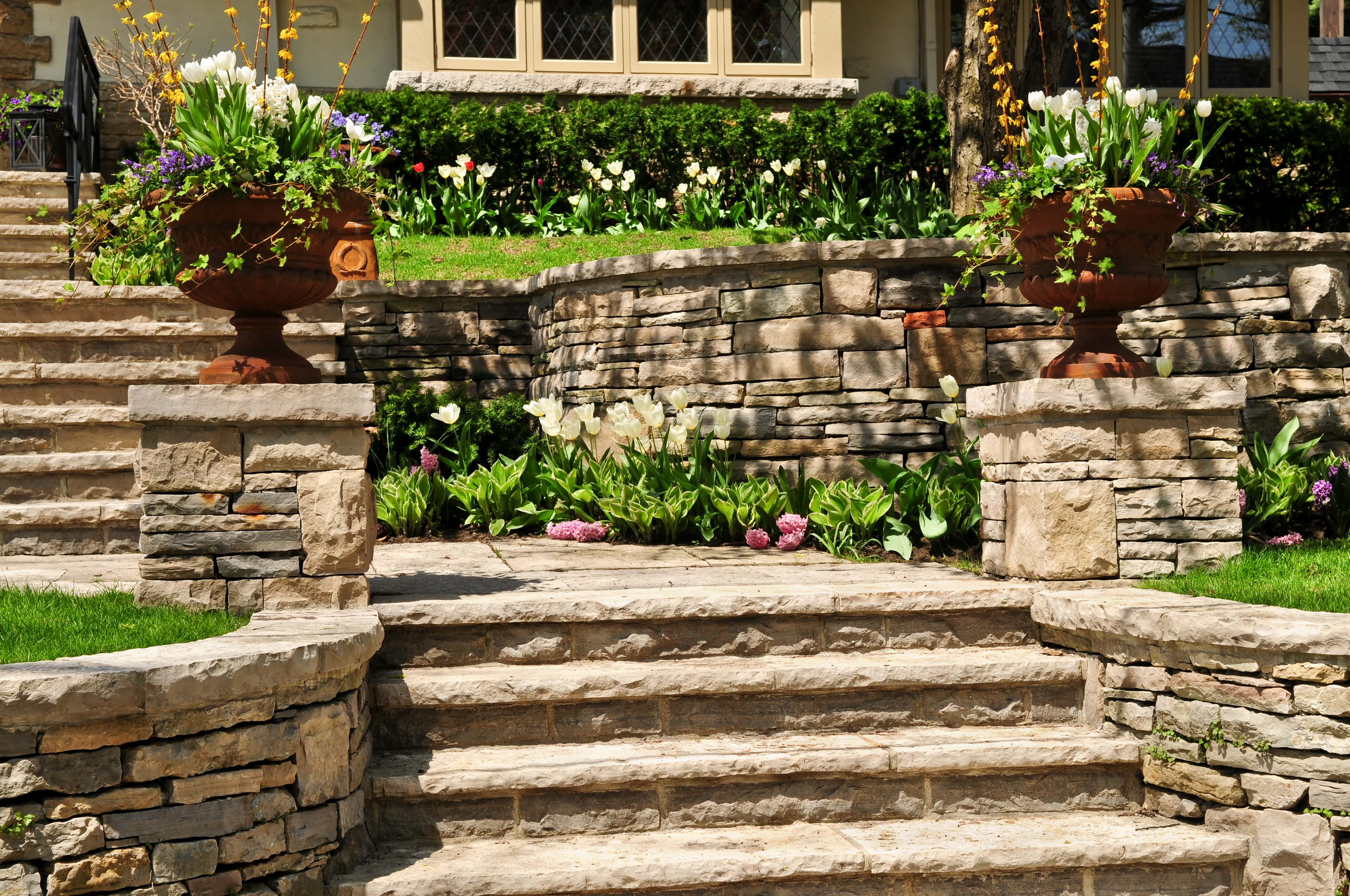 A stone retaining wall with built in stone steps