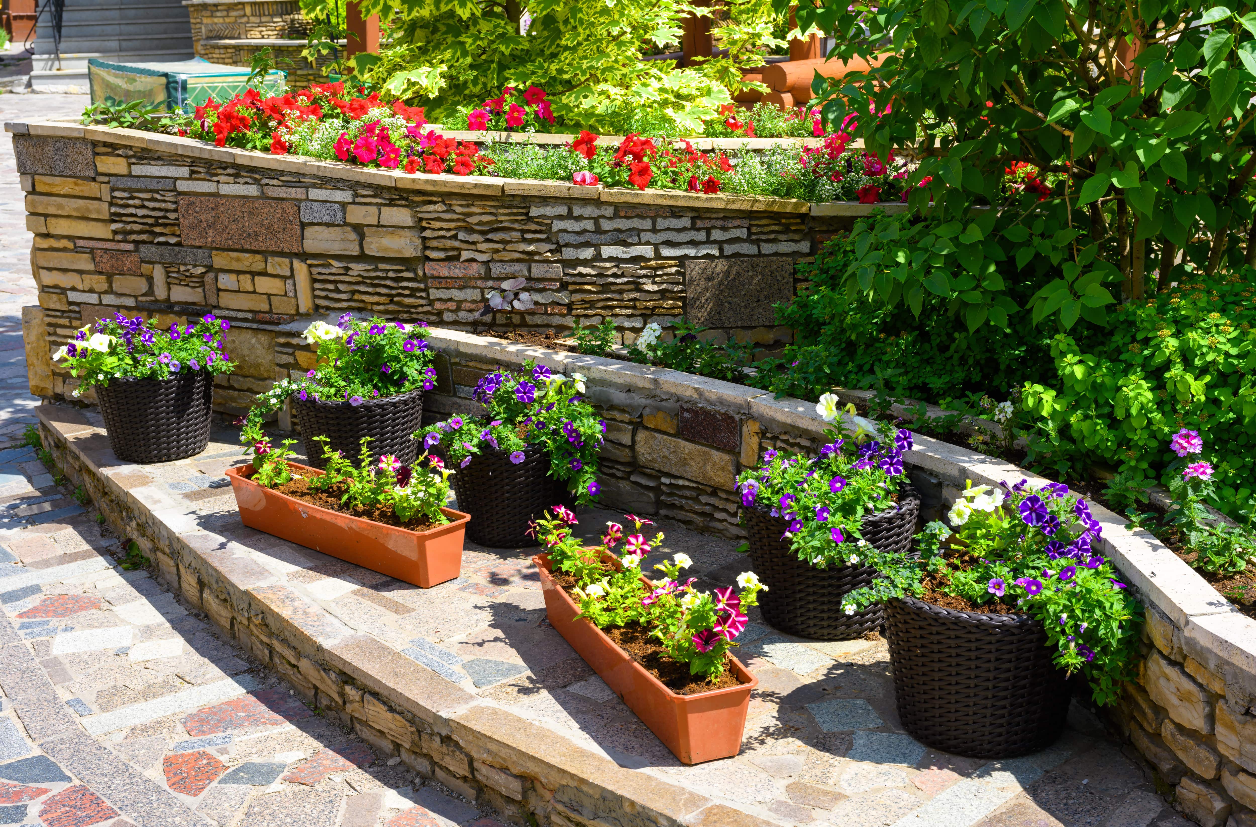 A multi-level retaining wall made of mixed rocks of different colors