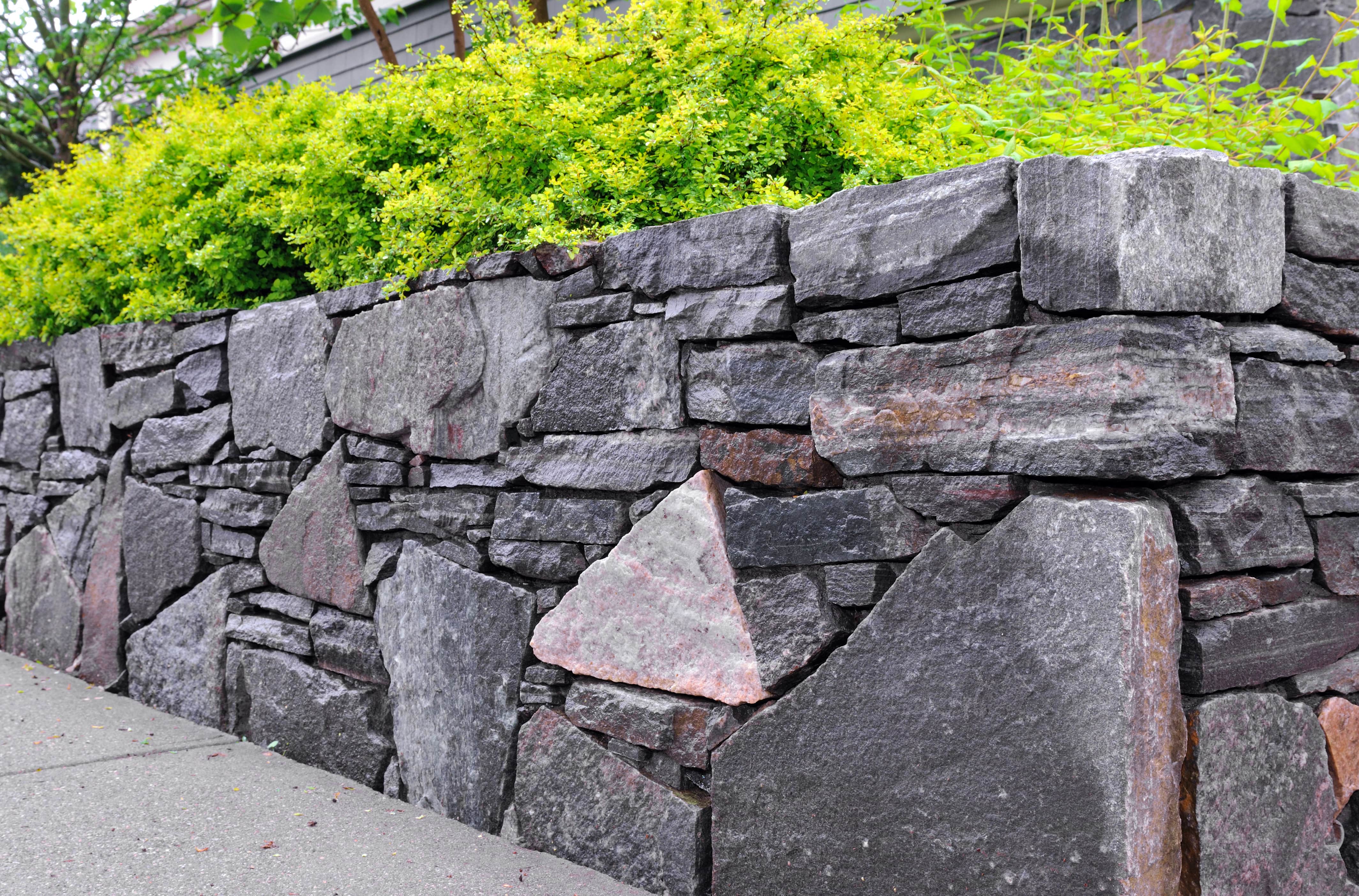 The corner of a retaining wall built from all stone