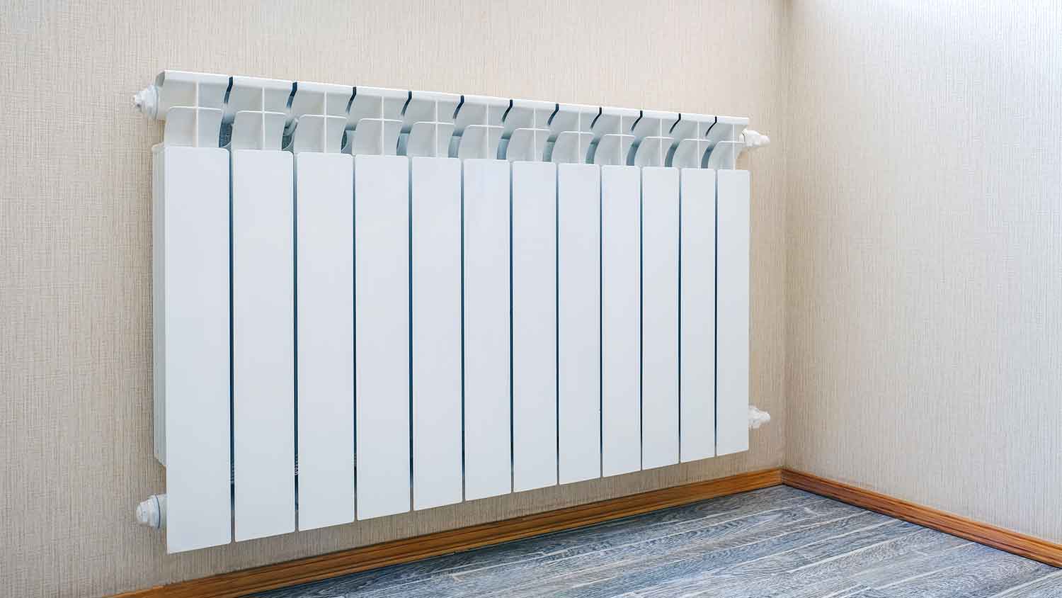 White panel radiator in the corner of the room