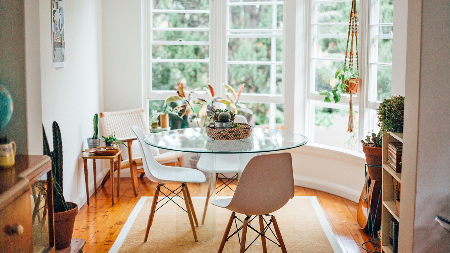 bright dining room with round glass table