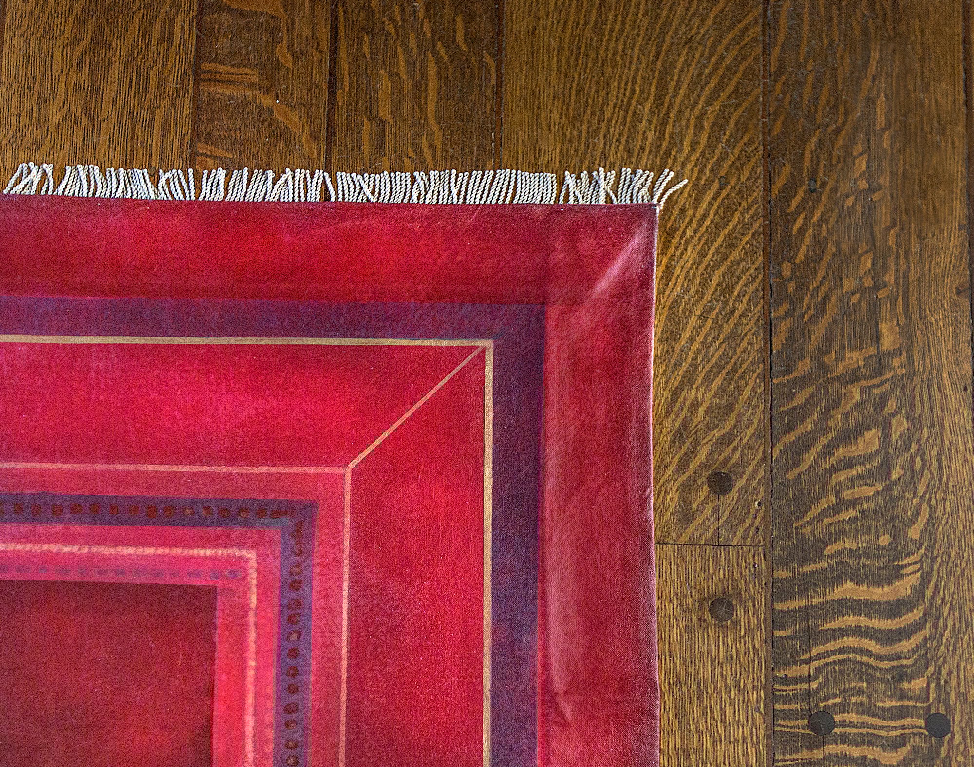red rug on hardwood floor