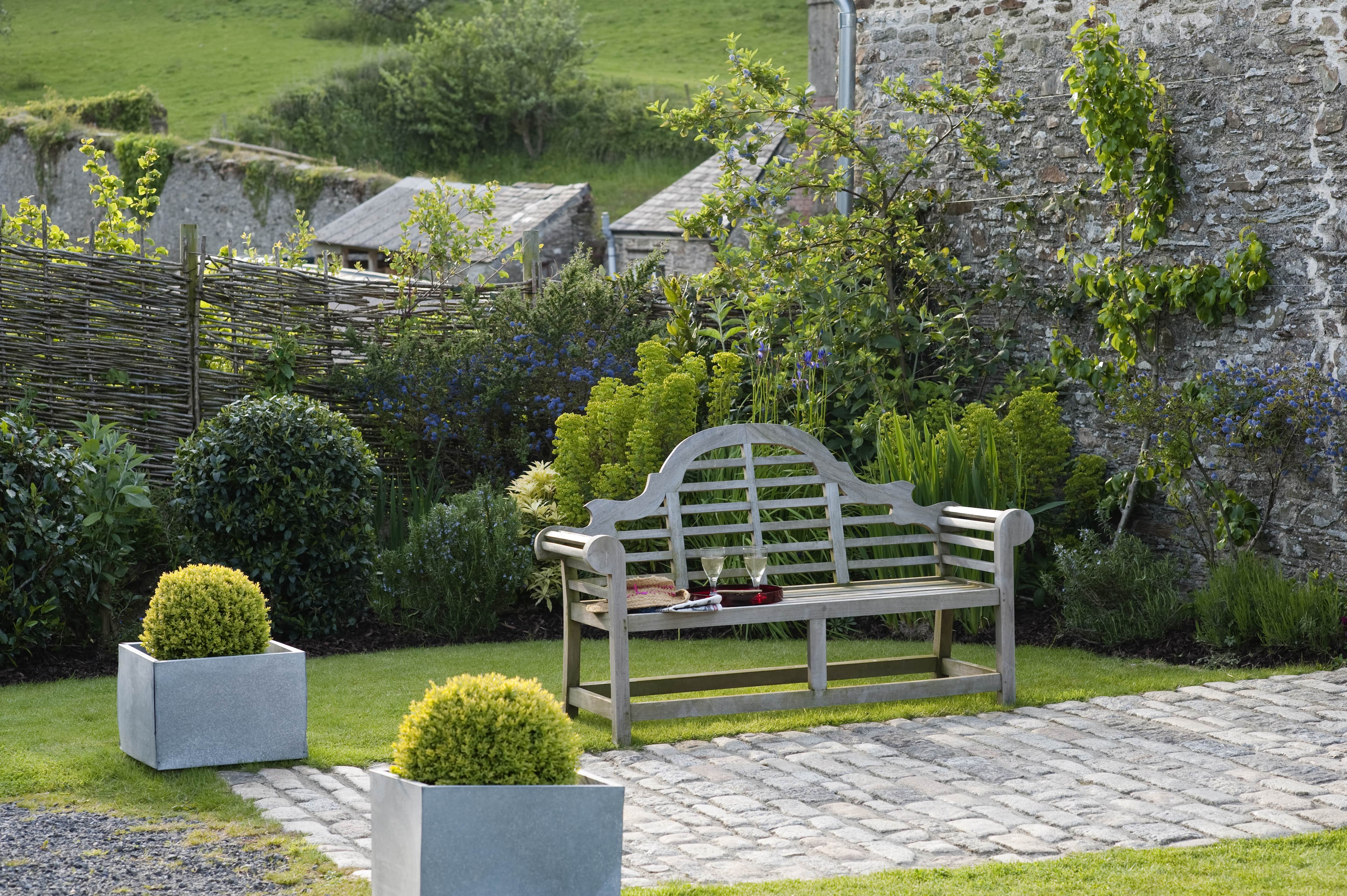 Historic farmhouse garden with bench