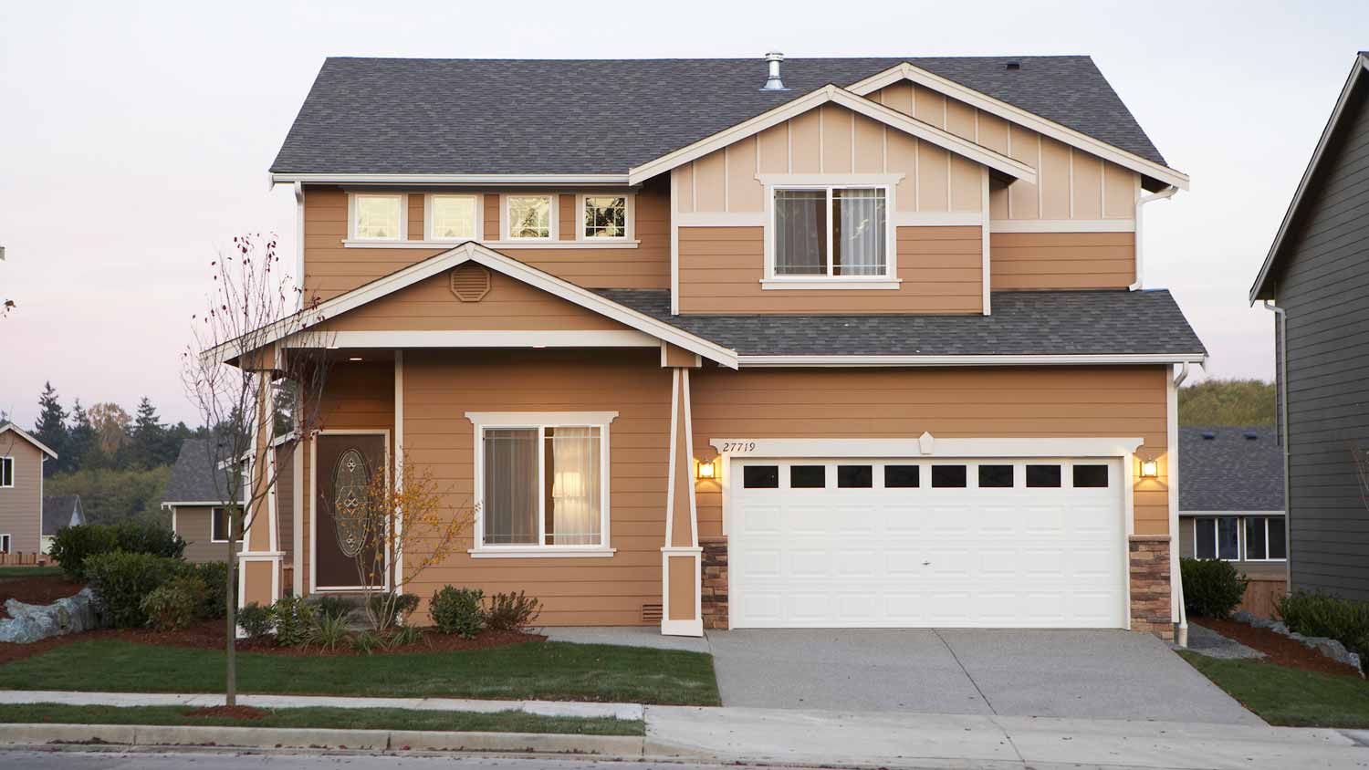 The exterior of a sable brown house at sunset