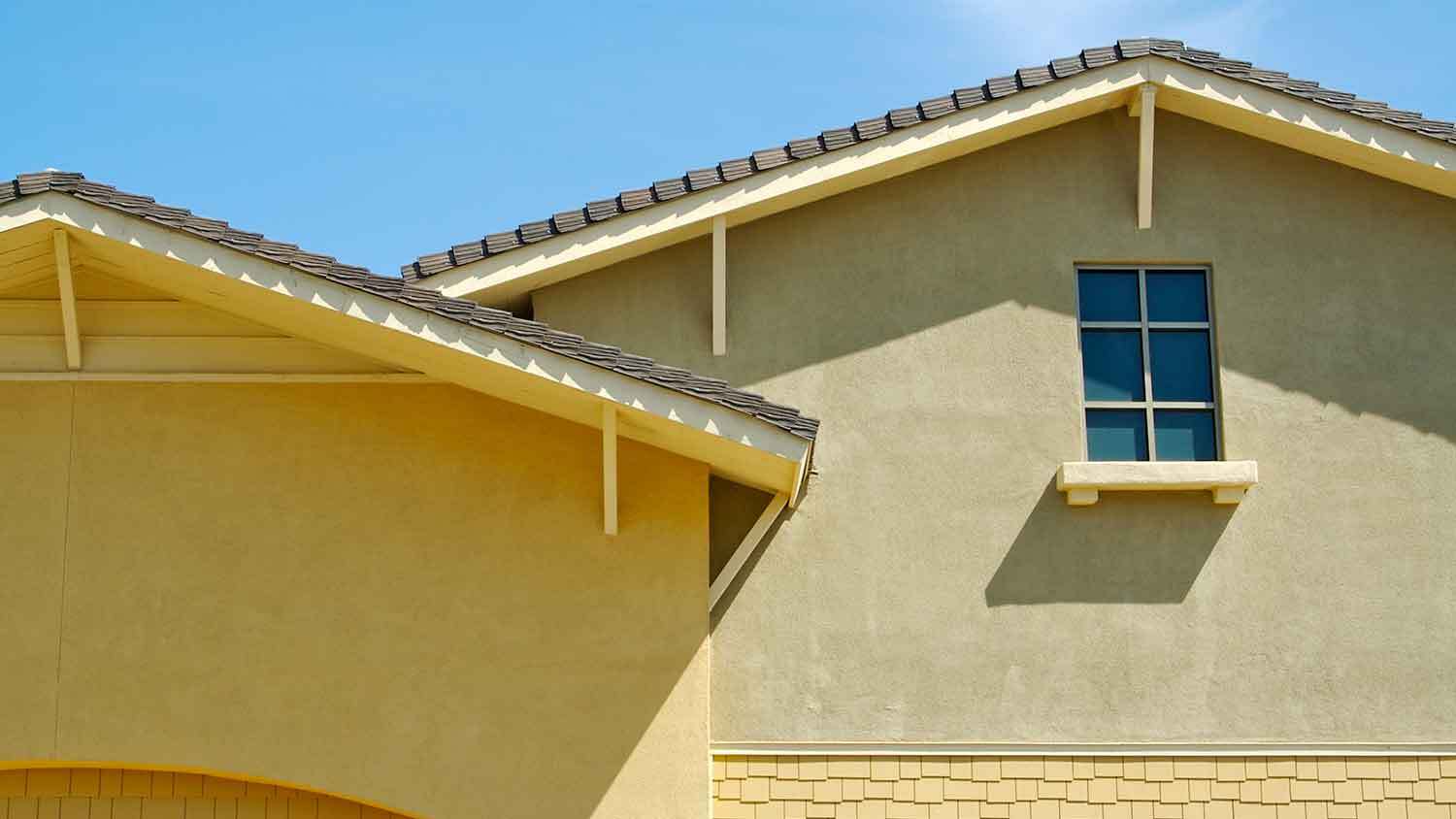 Window on a house with sand stucco texture