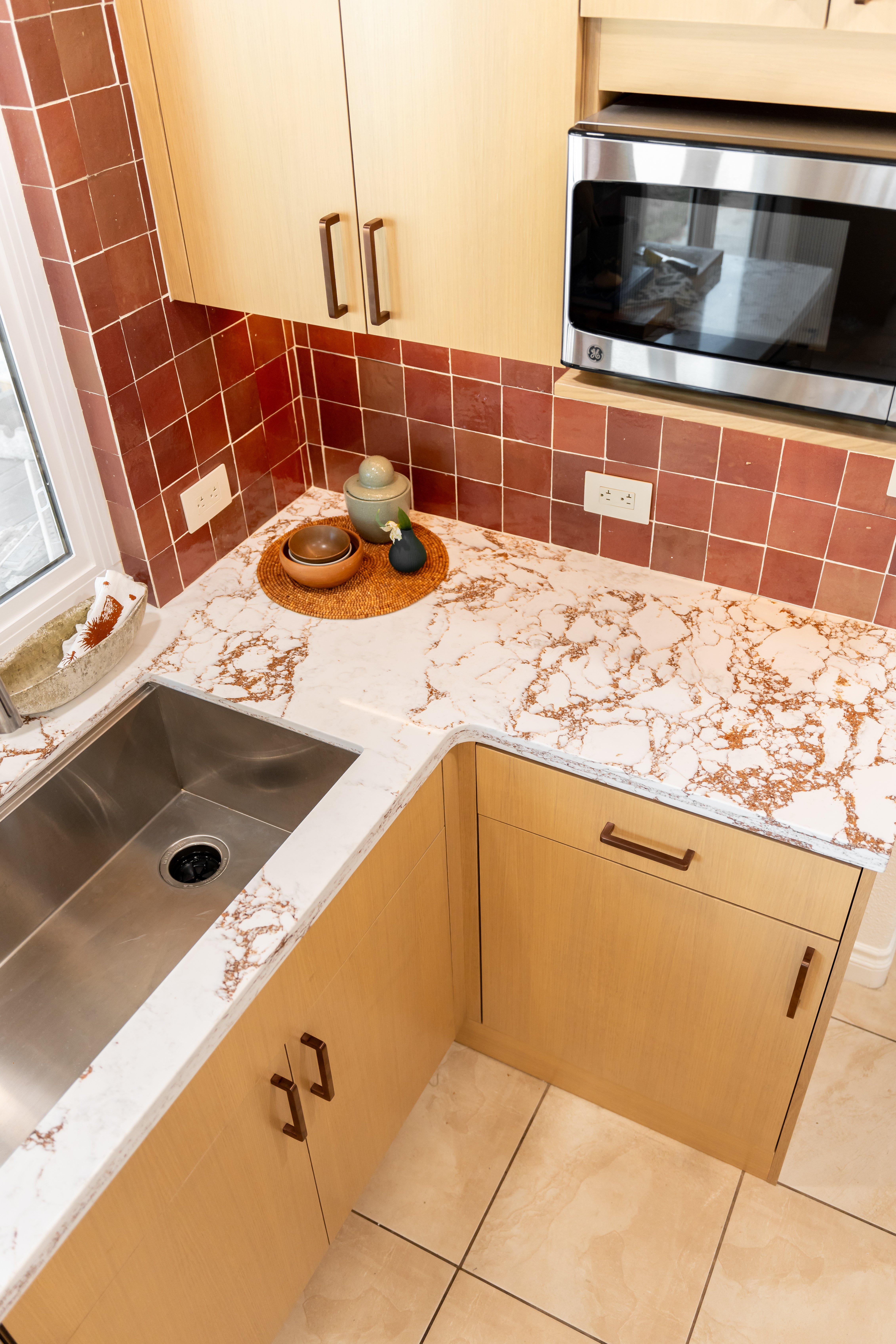 overhead view of renovated kitchen with quartz countertop and sink
