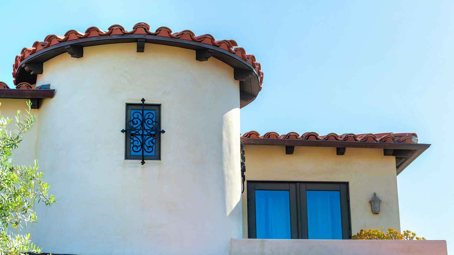 Spanish-style house with Santa Barbara stucco finish and a small window