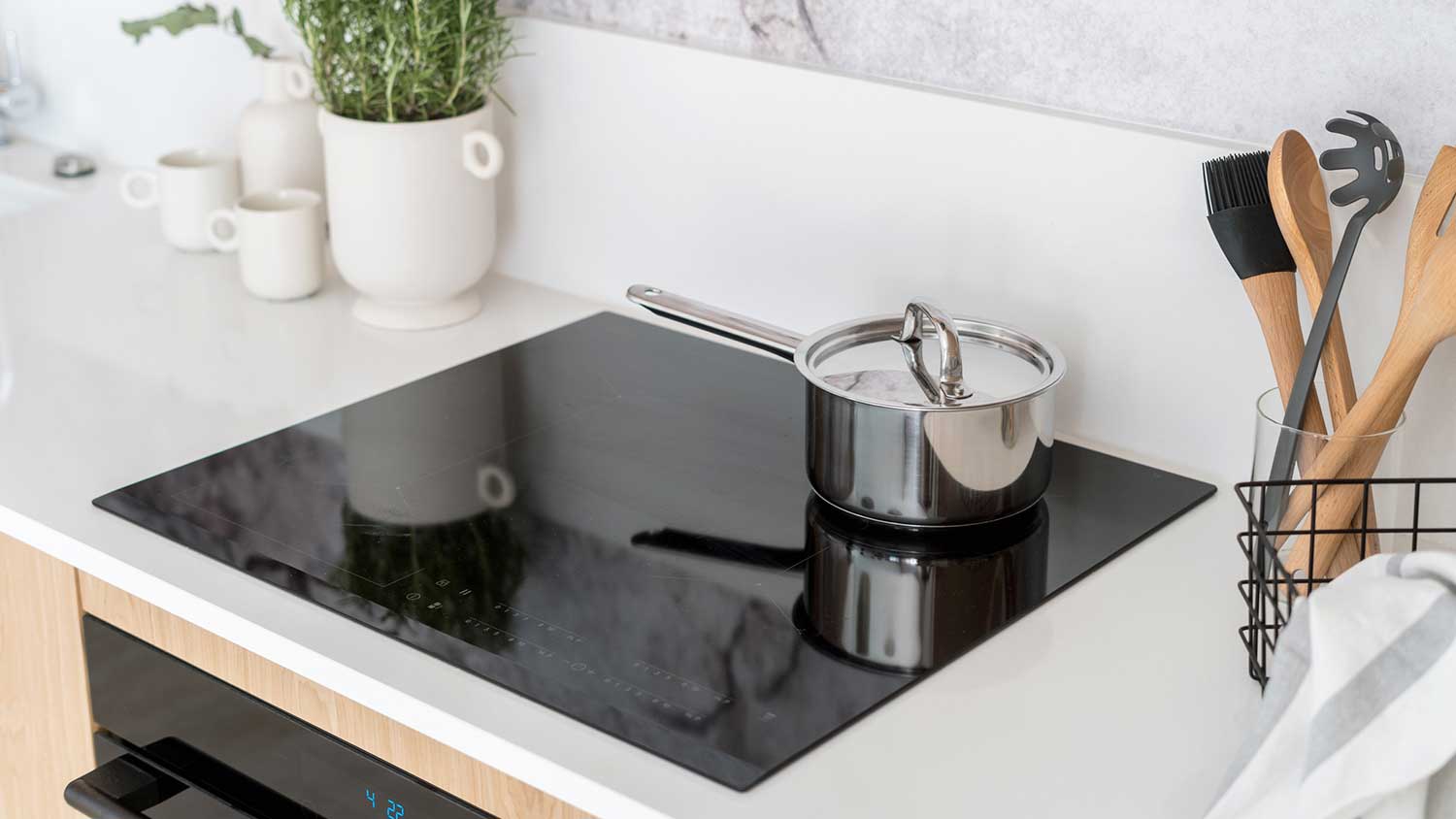 Saucepan with lid on modern induction range