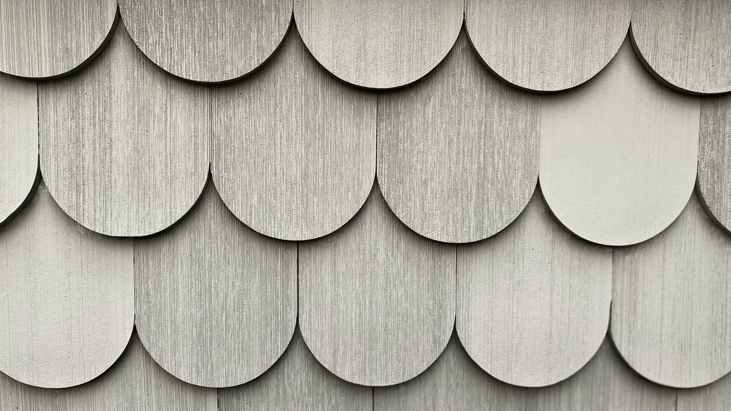 Gray scalloped shingle siding.
