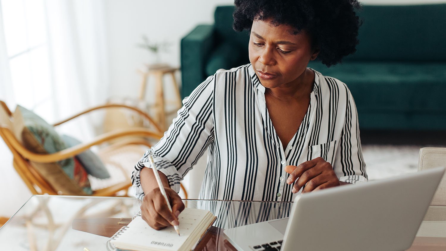 woman writing in planner	