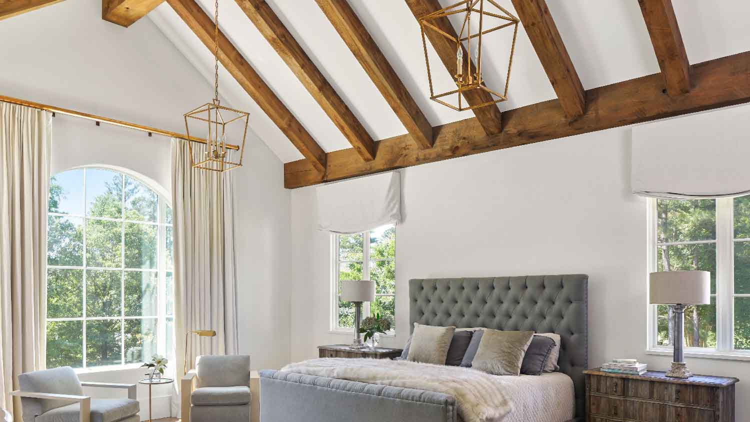 A bedroom with a scissor roof truss