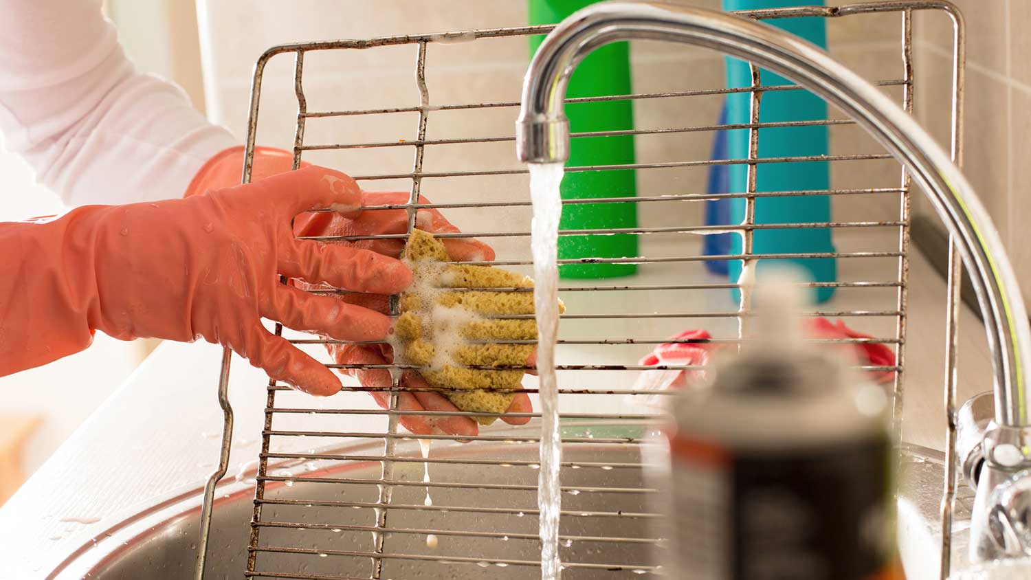 Scrubbing oven rack in the kitchen sink