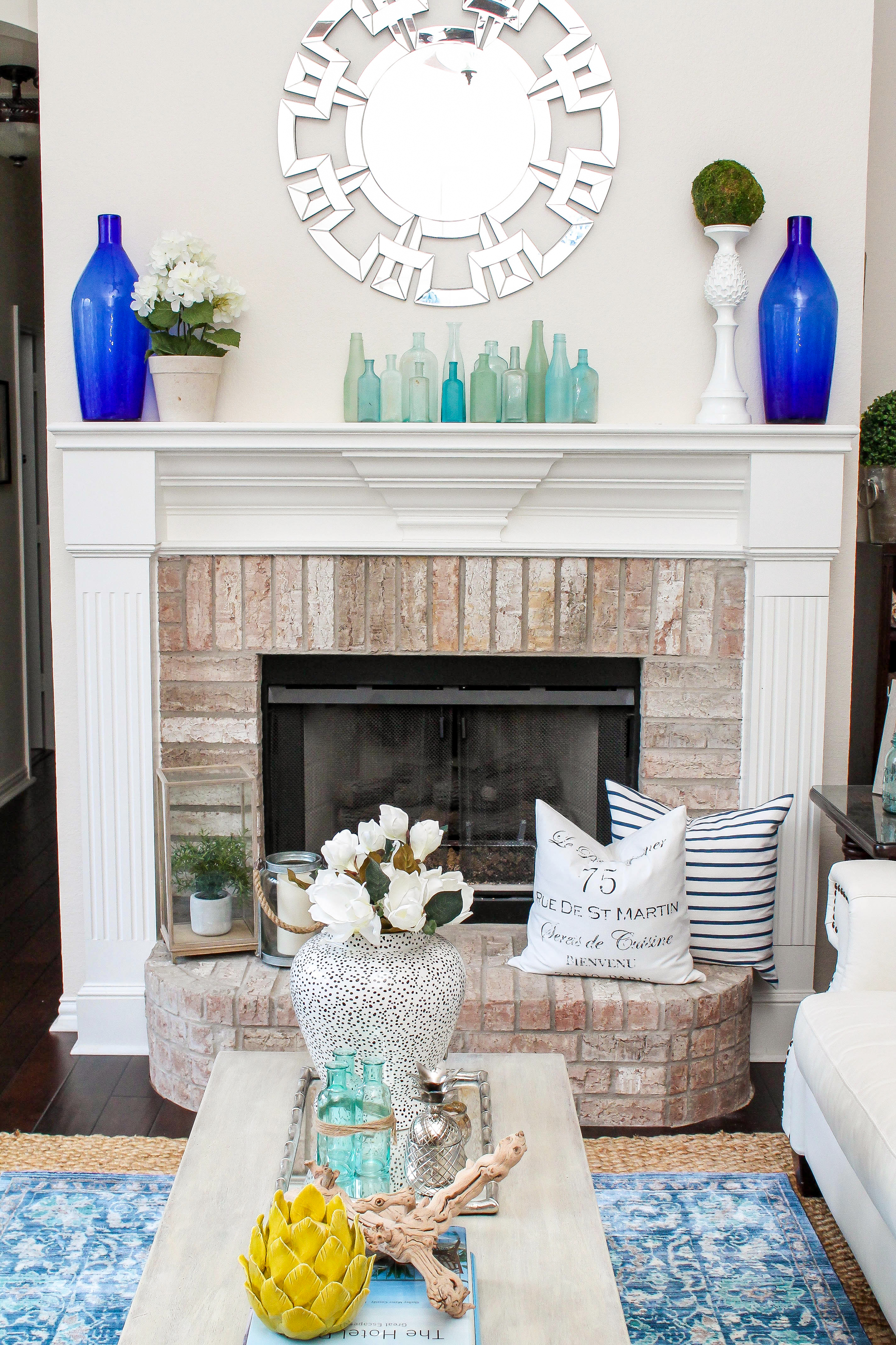 sea glass bottles decorating fireplace mantel