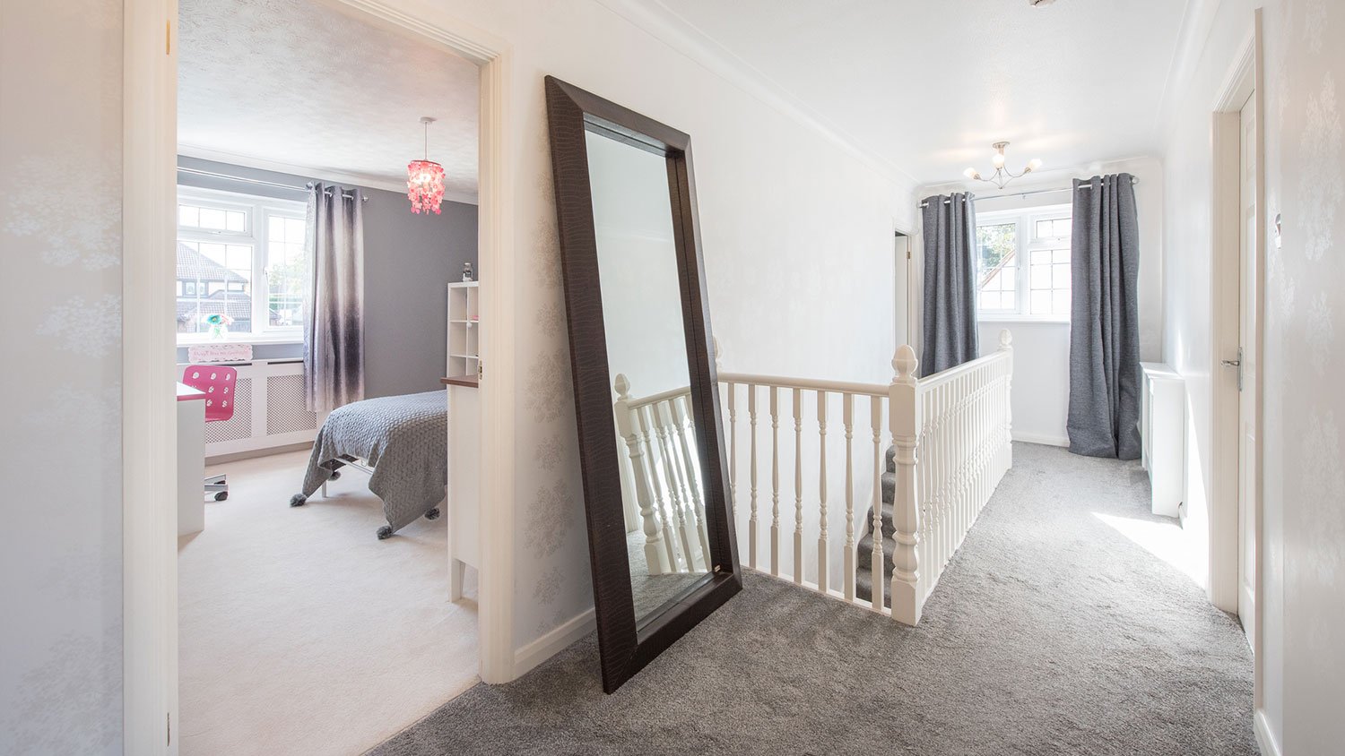 Second floor landing area with gray carpet