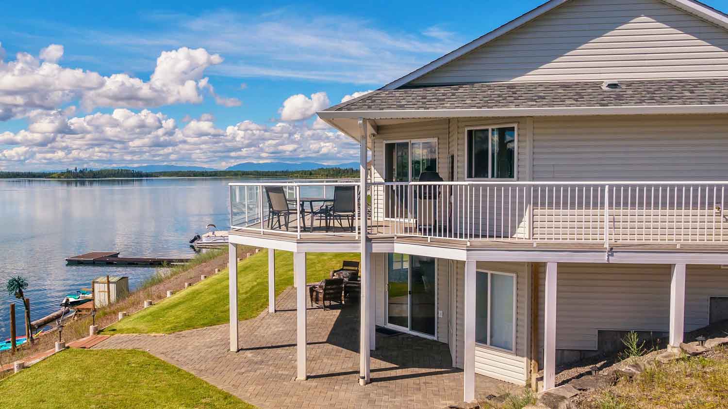 A second-story deck with glass railings