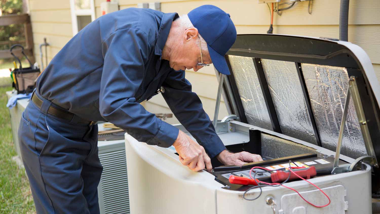 A senior electrician installing a generator