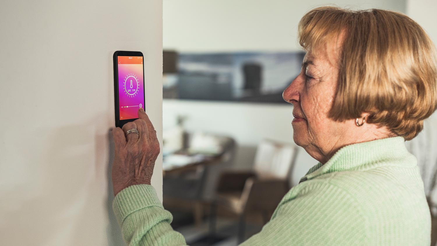 senior woman packing smart thermostat