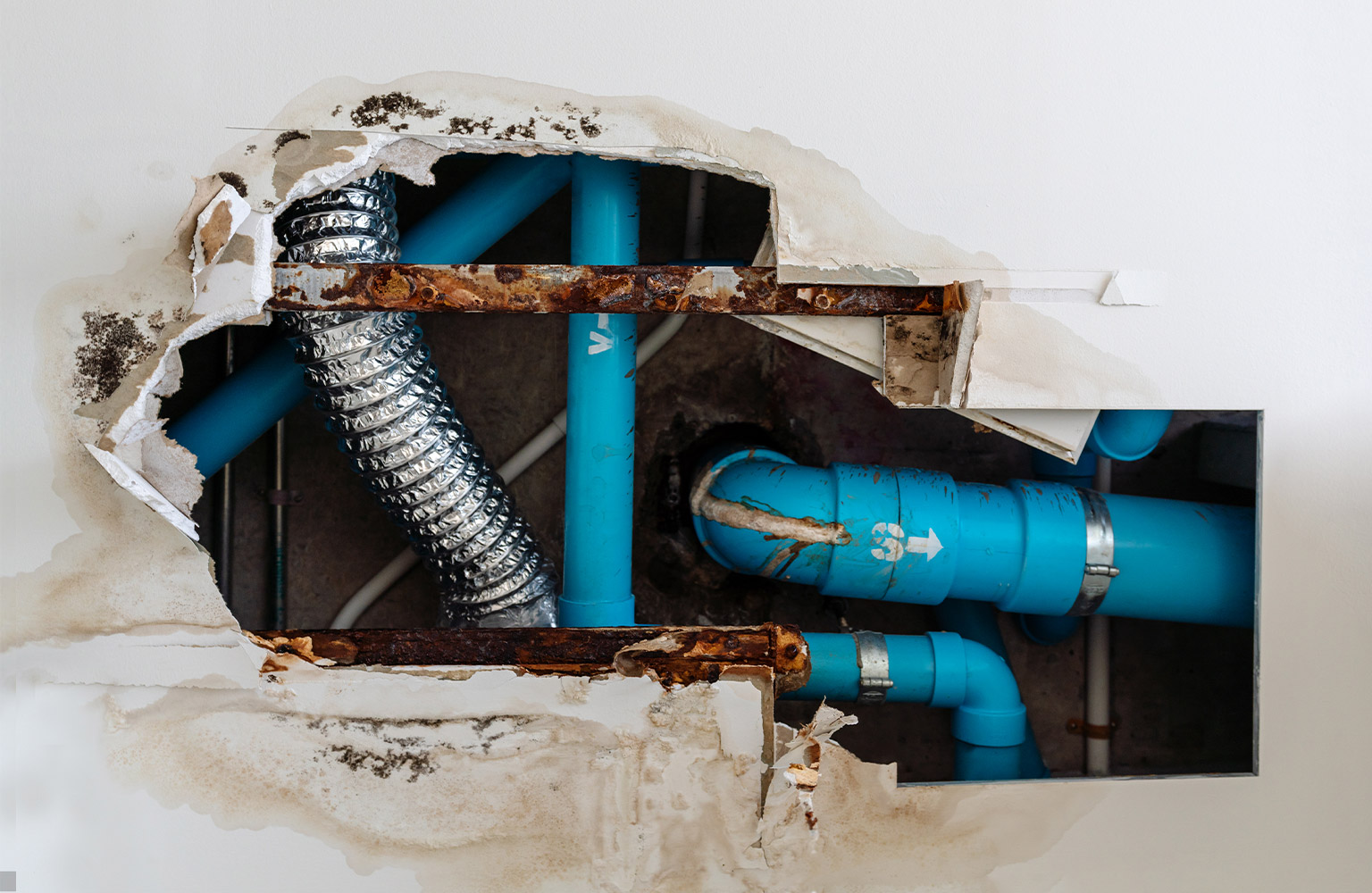 broken wall with exposed pipes