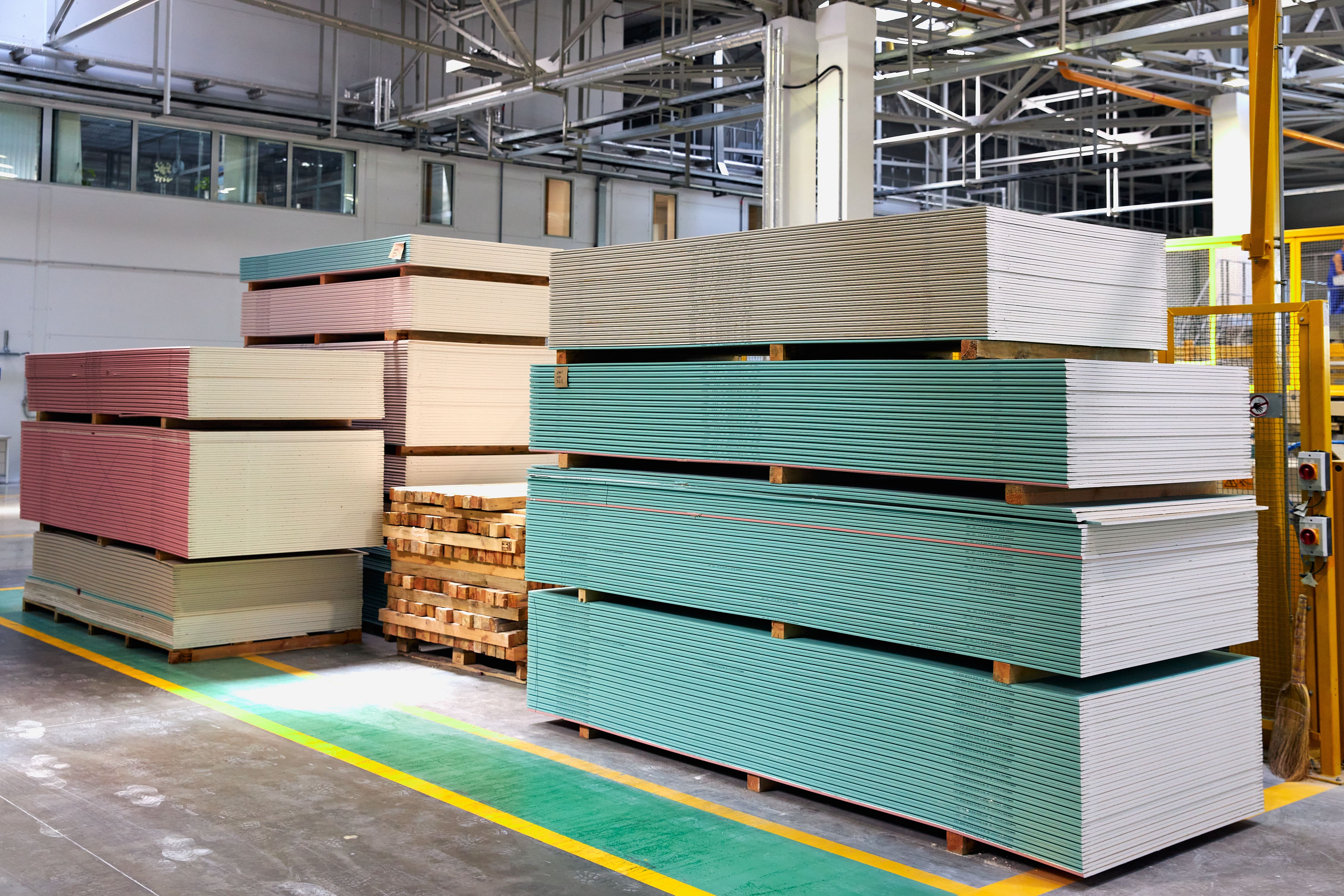 Different types of drywall stacked in large warehouse