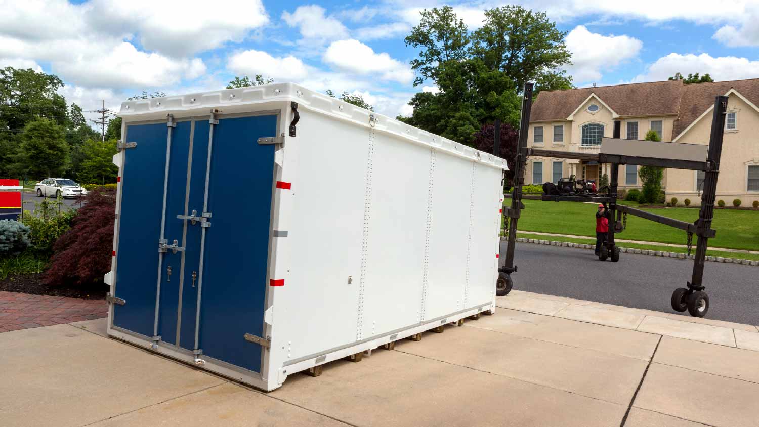 A shipping container dropped in a house’s driveway