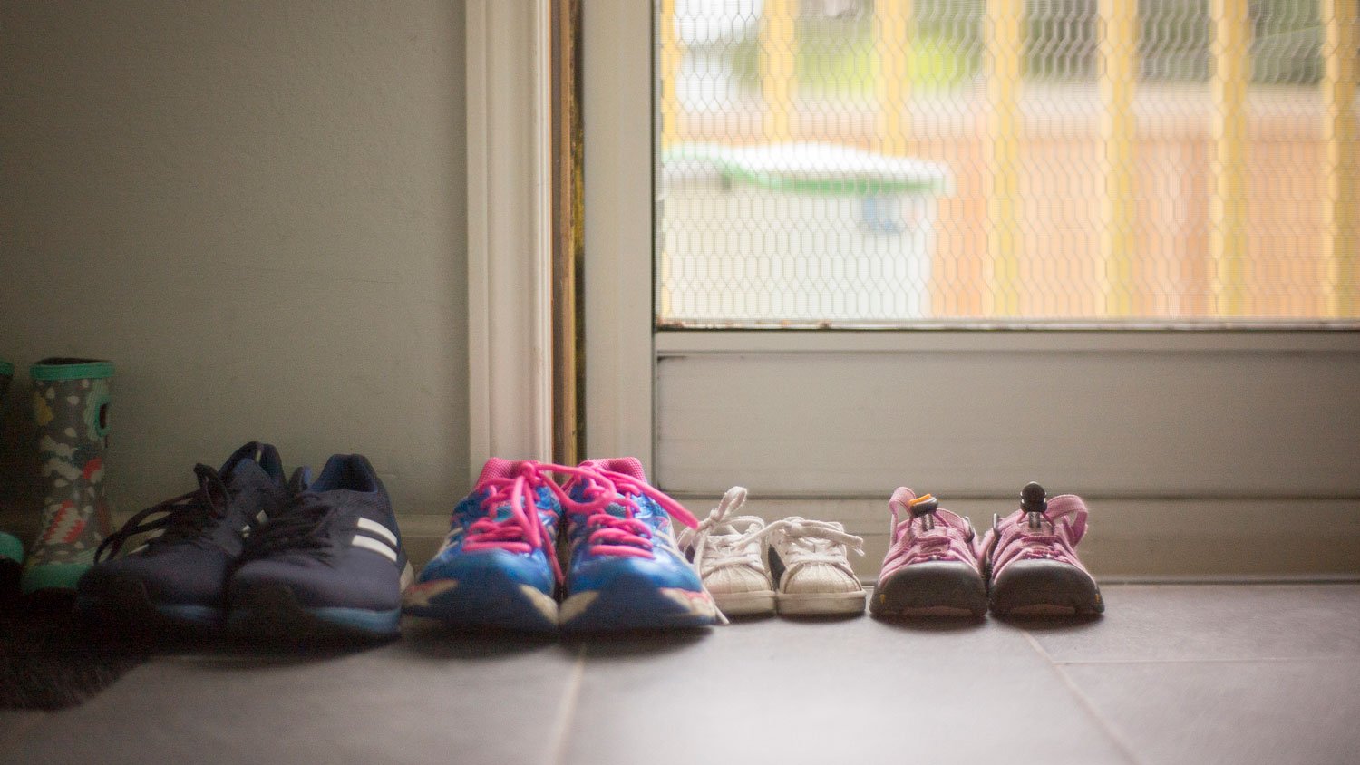Shoes of various sizes sitting near the front door