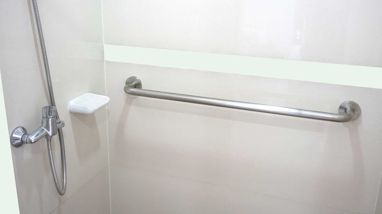 Grab bar mounted on a shower wall