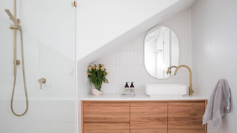 bathroom with shower, sink, and mirror