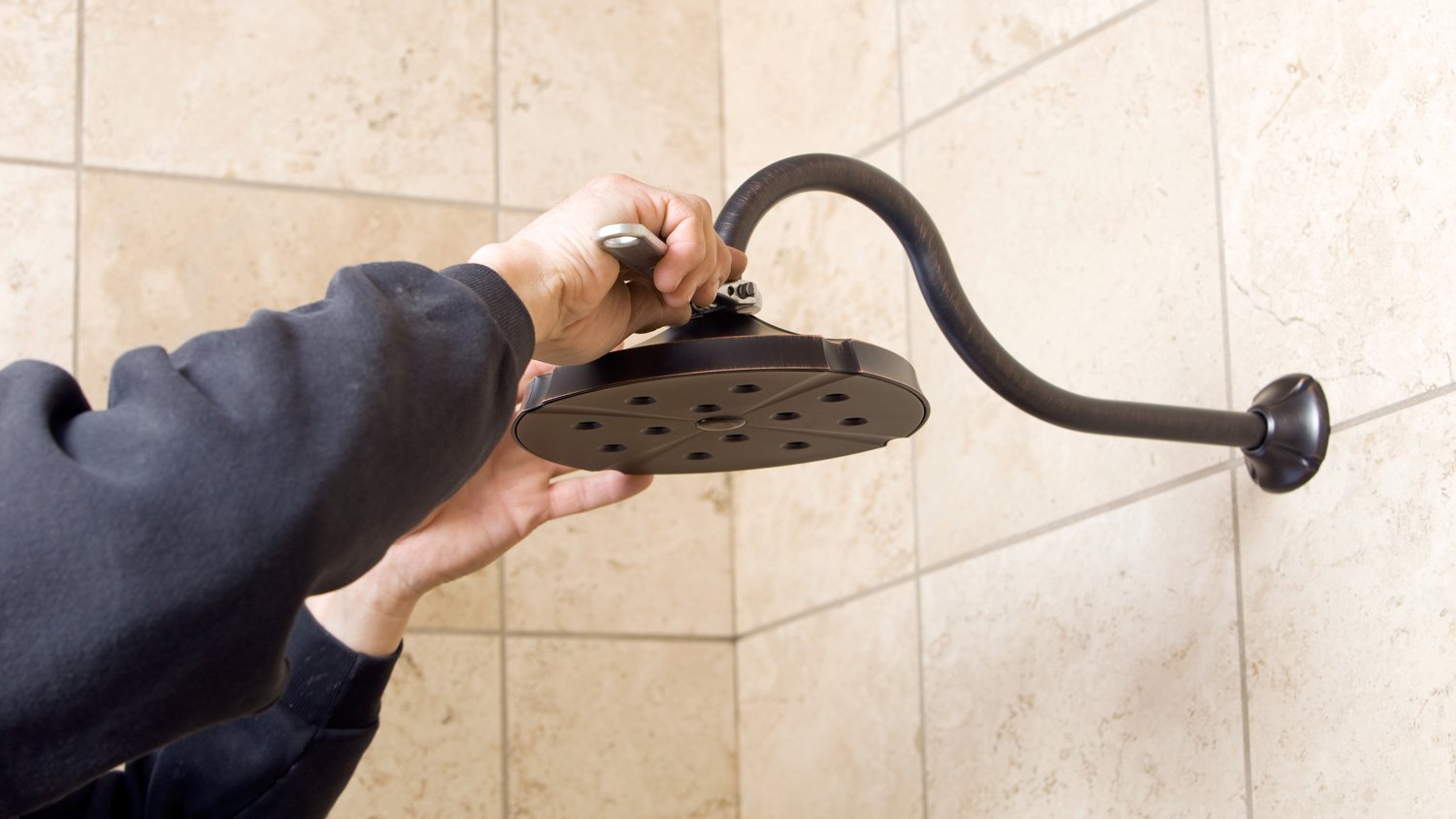 Plumber installing shower head