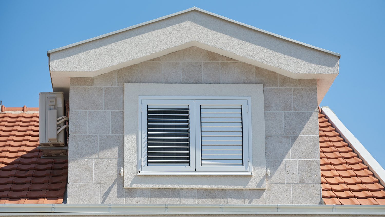 Plastic external window shutters on a residential building