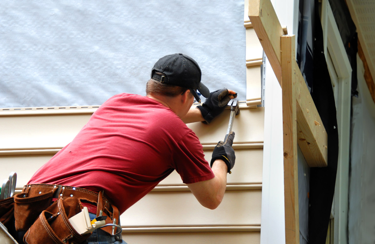 contractor working on home siding 