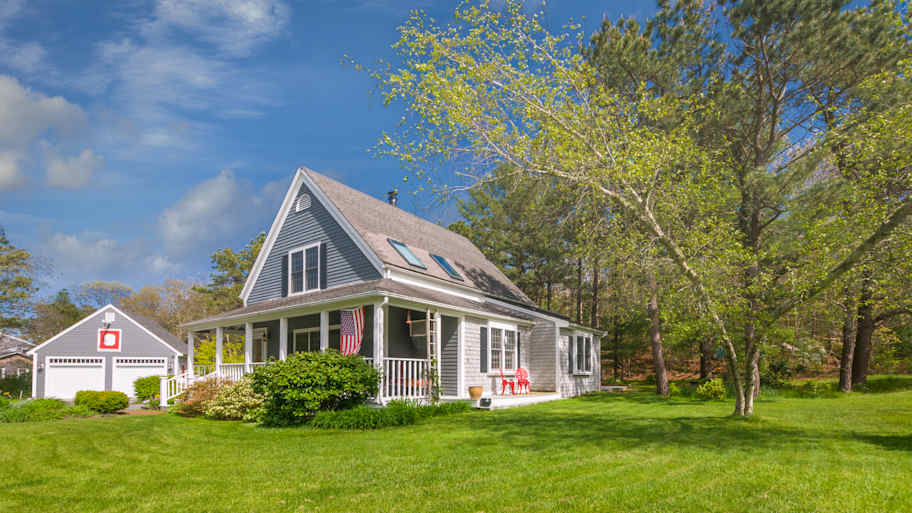 A beautiful single family house with a lawn in its yard