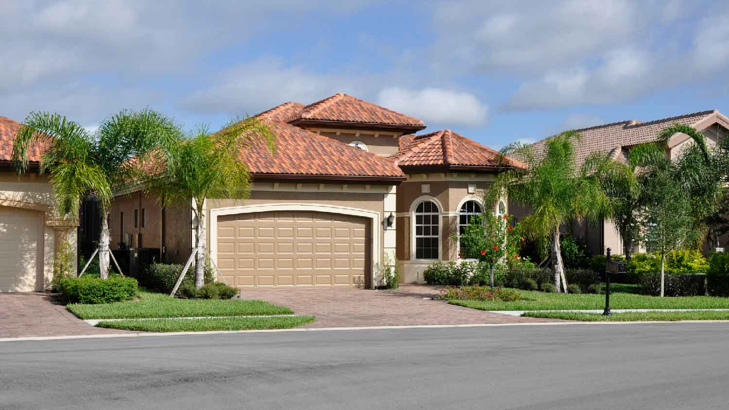 A single family house with a paver driveway