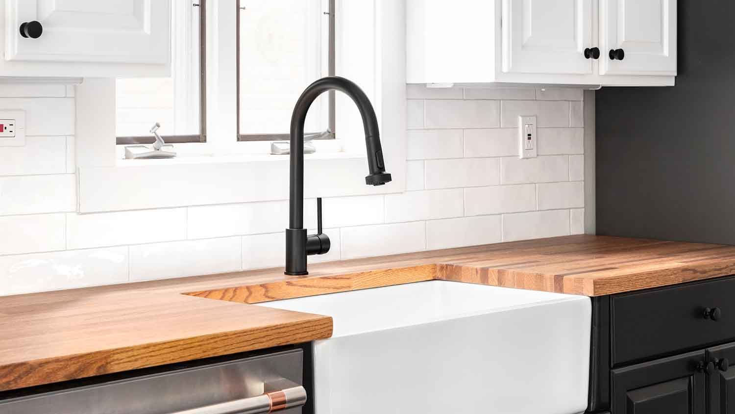 Black single handle faucet installed in the kitchen