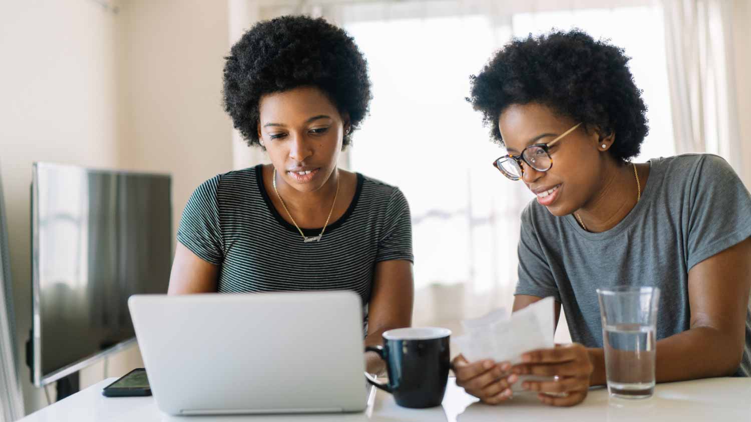 Sisters doing home finance at home